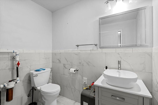 17205 County Line Rd, Elgin, TX 78621 - half bathroom featuring tile walls, vanity, and wainscoting