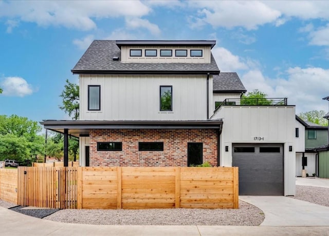 1713 E M Franklin Ave Unit 1, Austin, TX 78721 - view of front of house with board and batten siding, a shingled roof, and driveway