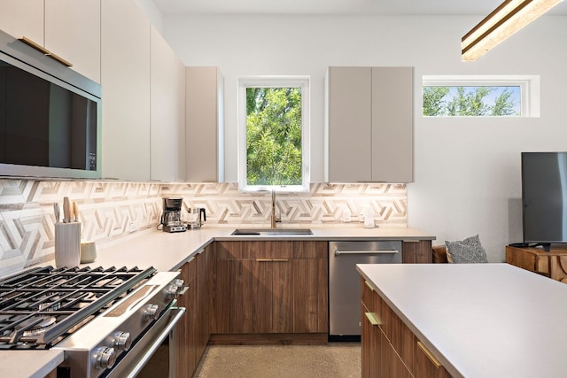 1713 E M Franklin Ave Unit 1, Austin, TX 78721 - kitchen featuring modern cabinets, stainless steel appliances, backsplash, and light countertops