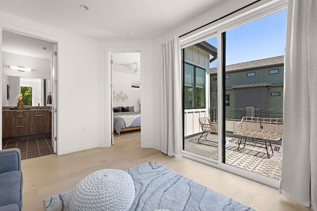 1713 E M Franklin Ave Unit 1, Austin, TX 78721 - bedroom with wood finished floors, access to exterior, and ensuite bathroom
