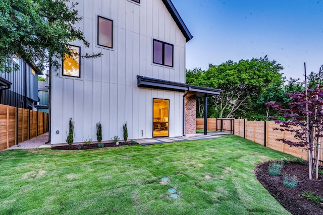 1713 E M Franklin Ave Unit 1, Austin, TX 78721 - rear view of property with board and batten siding and a fenced backyard