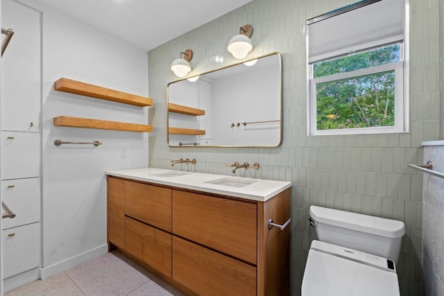 1701 Brentwood St, Austin, TX 78757 - full bathroom featuring double vanity, tile walls, and speckled floor