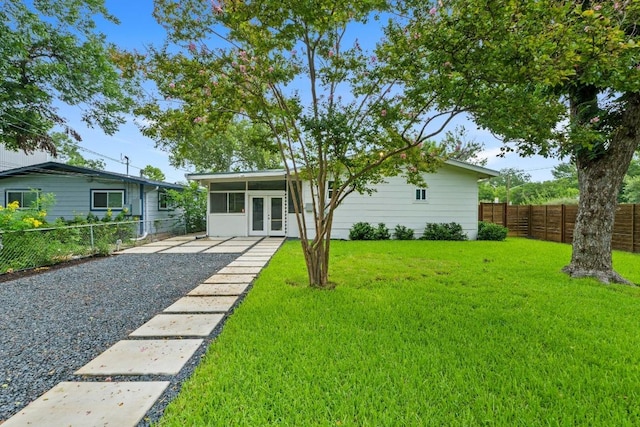 1701 Brentwood St, Austin, TX 78757 - view of front facade featuring french doors and a fenced backyard