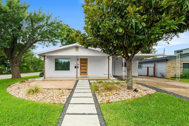 1701 Brentwood St, Austin, TX 78757 - view of front of house featuring an attached carport, concrete driveway, a porch, and a front yard