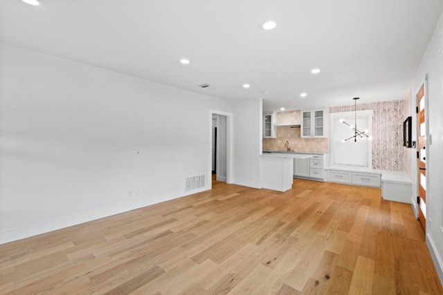 1701 Brentwood St, Austin, TX 78757 - unfurnished living room featuring light wood-style flooring and recessed lighting