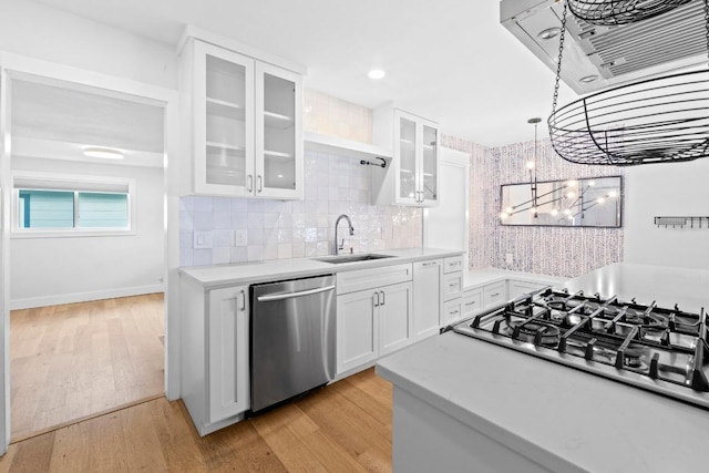 1701 Brentwood St, Austin, TX 78757 - kitchen with stainless steel appliances, a chandelier, light countertops, and white cabinets
