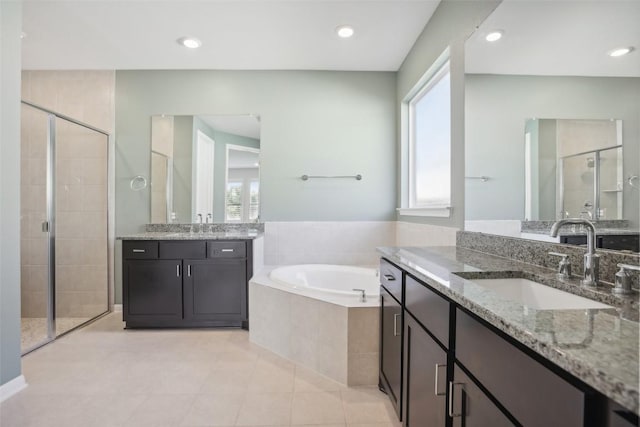 807 Arrowhead Ranch Blvd, Dripping Springs, TX 78620 - bathroom featuring a shower stall, plenty of natural light, a garden tub, two vanities, and recessed lighting