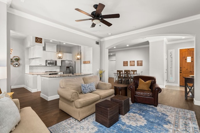 7800 SW Pkwy Unit 610, Austin, TX 78735 - living room with arched walkways, a ceiling fan, dark wood-style floors, recessed lighting, and crown molding
