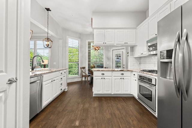 7800 SW Pkwy Unit 610, Austin, TX 78735 - kitchen with stainless steel appliances, white cabinetry, dark wood-style flooring, and light stone countertops