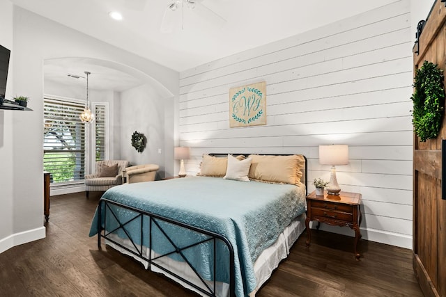 7800 SW Pkwy Unit 610, Austin, TX 78735 - bedroom with dark wood-style flooring, arched walkways, wooden walls, recessed lighting, and ceiling fan