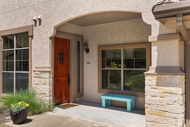 7800 SW Pkwy Unit 610, Austin, TX 78735 - doorway to property with stucco siding and stone siding