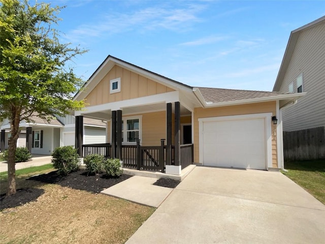 312 La Escalera Dr, Leander, TX 78641 - view of front of property with a porch, board and batten siding, a garage, driveway, and a shingled roof