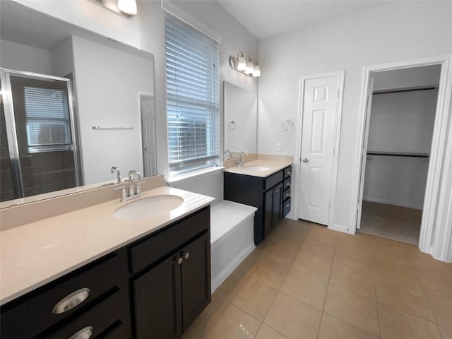 312 La Escalera Dr, Leander, TX 78641 - full bathroom featuring a shower stall, two vanities, and tile patterned flooring
