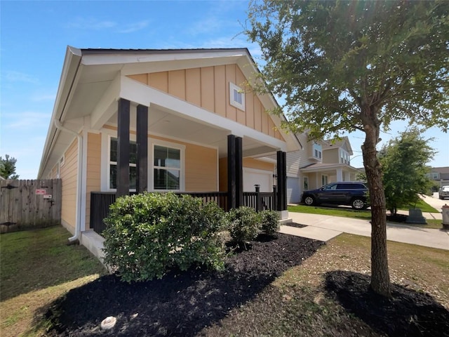 312 La Escalera Dr, Leander, TX 78641 - view of front facade with board and batten siding, concrete driveway, and covered porch