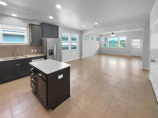 312 La Escalera Dr, Leander, TX 78641 - kitchen with stainless steel fridge, healthy amount of natural light, light countertops, open floor plan, and recessed lighting