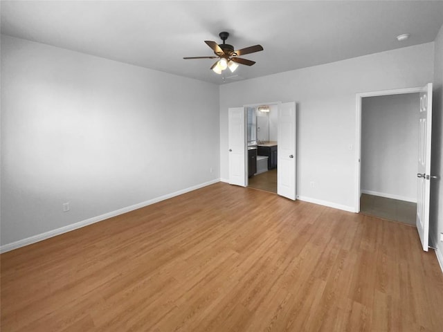 312 La Escalera Dr, Leander, TX 78641 - unfurnished bedroom with light wood finished floors, ensuite bathroom, and a ceiling fan