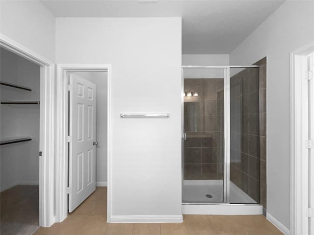 312 La Escalera Dr, Leander, TX 78641 - full bath featuring tile patterned floors, a shower stall, and a walk in closet