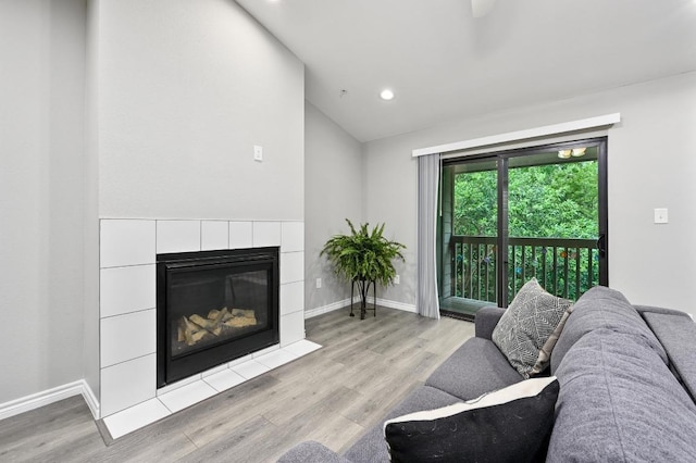 3839 Dry Creek Dr Unit 207, Austin, TX 78731 - living room featuring light wood finished floors, lofted ceiling, recessed lighting, and a tile fireplace