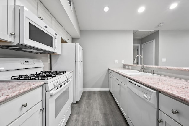 3839 Dry Creek Dr Unit 207, Austin, TX 78731 - kitchen featuring white appliances, recessed lighting, light countertops, dark wood-style floors, and white cabinets