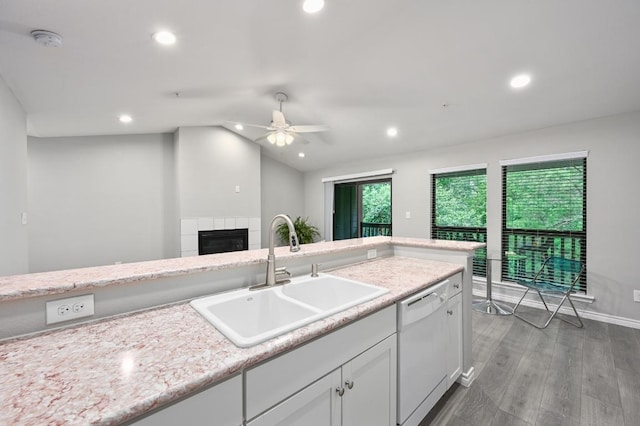 3839 Dry Creek Dr Unit 207, Austin, TX 78731 - kitchen featuring white dishwasher, a fireplace, a ceiling fan, recessed lighting, and white cabinets
