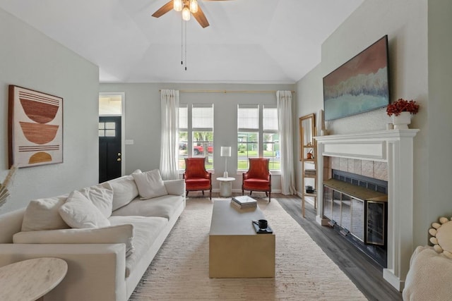 2134 Cervin Blvd, Austin, TX 78728 - living room featuring wood finished floors, ceiling fan, a tile fireplace, and vaulted ceiling