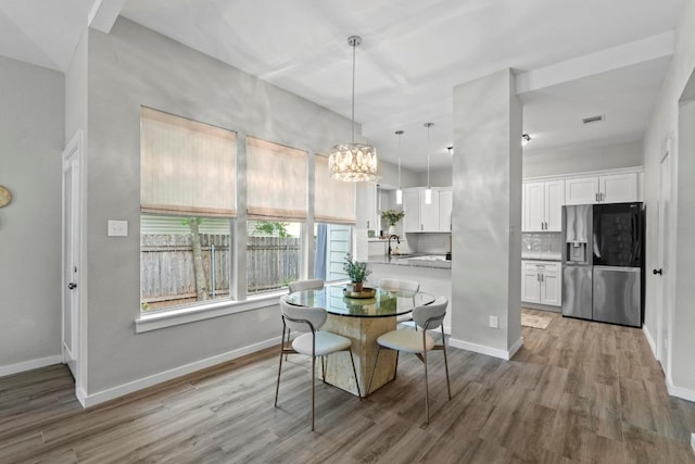 2134 Cervin Blvd, Austin, TX 78728 - dining room featuring wood finished floors and a chandelier