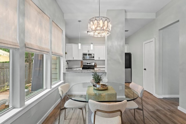 2134 Cervin Blvd, Austin, TX 78728 - dining room with dark wood-style floors and a chandelier