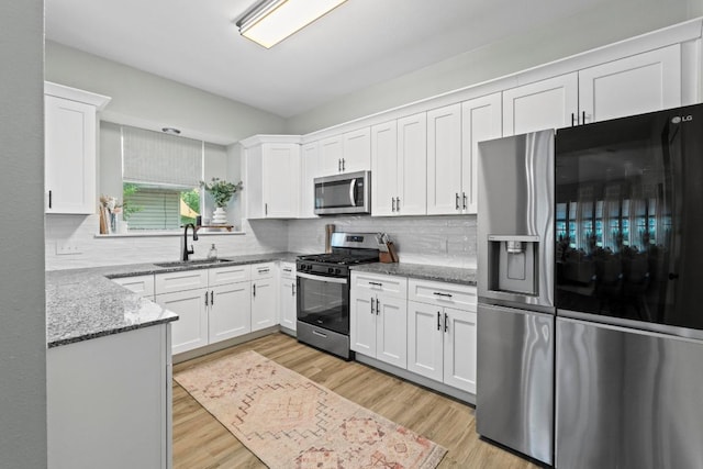 2134 Cervin Blvd, Austin, TX 78728 - kitchen with stainless steel appliances, white cabinets, light stone countertops, light wood-style flooring, and tasteful backsplash