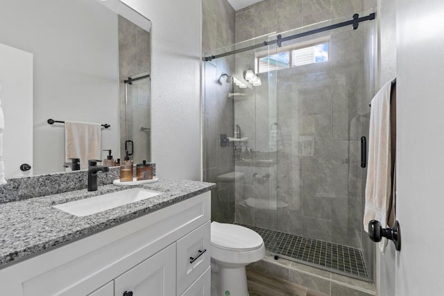 2134 Cervin Blvd, Austin, TX 78728 - bathroom with vanity, a shower stall, and wood finished floors