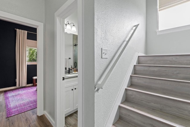 2134 Cervin Blvd, Austin, TX 78728 - stairs with wood finished floors, bar area, and a textured wall