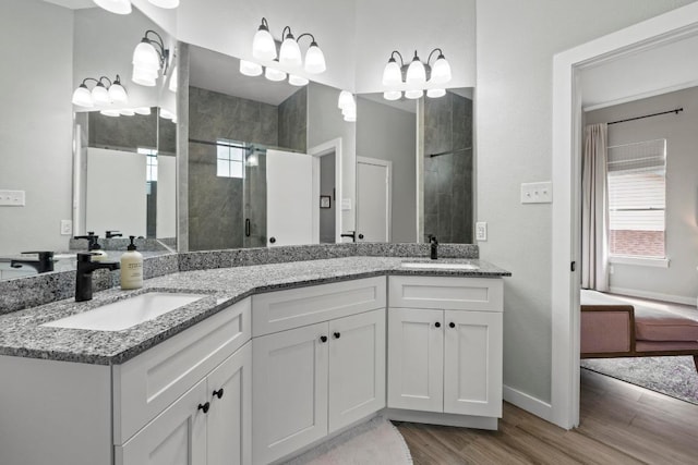 2134 Cervin Blvd, Austin, TX 78728 - ensuite bathroom with wood finished floors, double vanity, and a shower stall