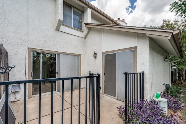 6910 Hart Ln Unit 807, Austin, TX 78731 - view of exterior entry with stucco siding and a patio
