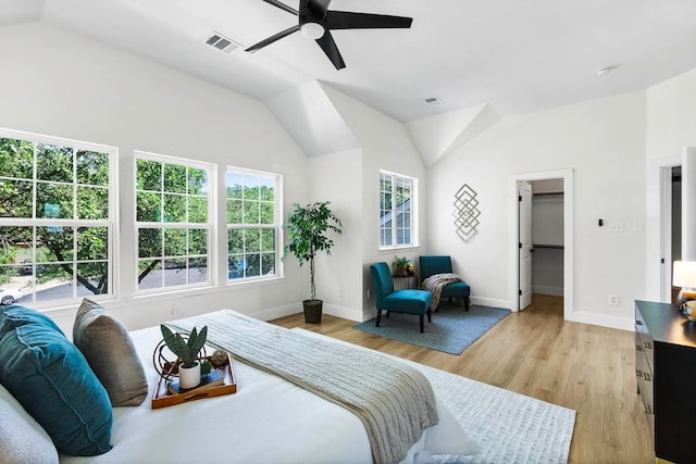 13305 Teton Ridge Cv, Austin, TX 78727 - bedroom with lofted ceiling, light wood finished floors, ceiling fan, and a walk in closet