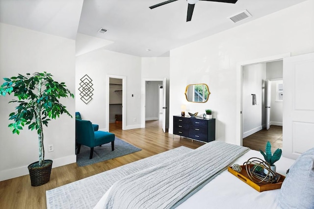 13305 Teton Ridge Cv, Austin, TX 78727 - bedroom with wood finished floors, a walk in closet, and a ceiling fan
