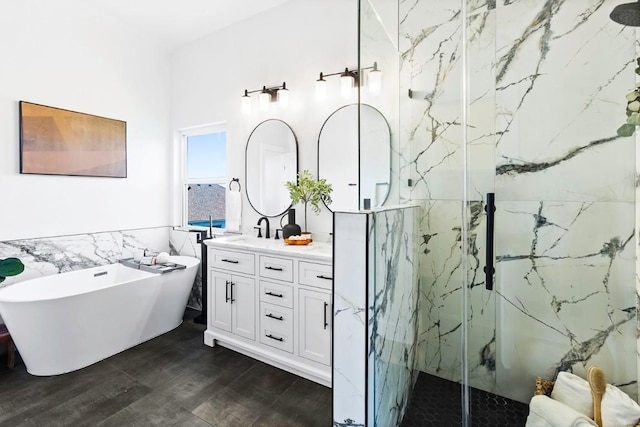 13305 Teton Ridge Cv, Austin, TX 78727 - bathroom with a marble finish shower, vanity, a soaking tub, tile walls, and wood finished floors