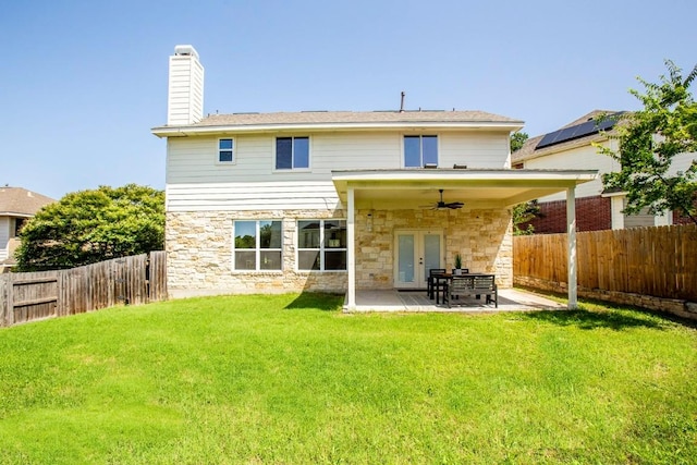 13305 Teton Ridge Cv, Austin, TX 78727 - back of property with a ceiling fan, french doors, stone siding, and a fenced backyard