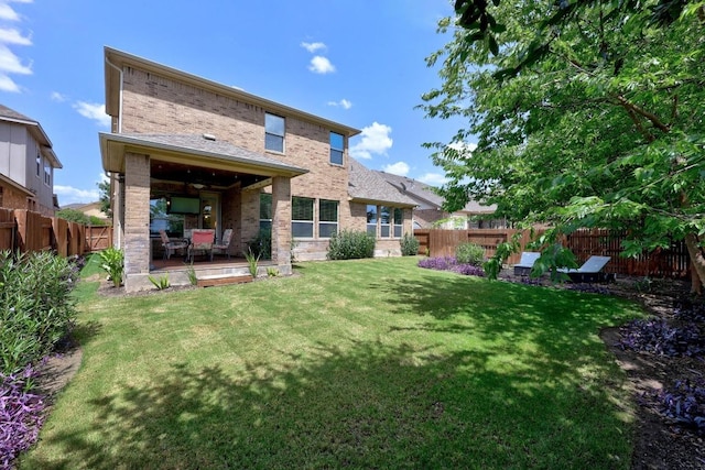 104 Atlanta Park Dr, Georgetown, TX 78628 - rear view of house featuring brick siding, a fenced backyard, and a patio area