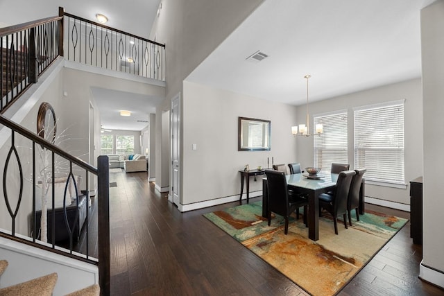104 Atlanta Park Dr, Georgetown, TX 78628 - dining room featuring a chandelier, stairway, dark wood-style floors, and baseboard heating
