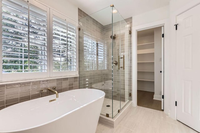 11108 Brista Way, Austin, TX 78726 - bathroom featuring a shower stall, a freestanding tub, and tile patterned flooring