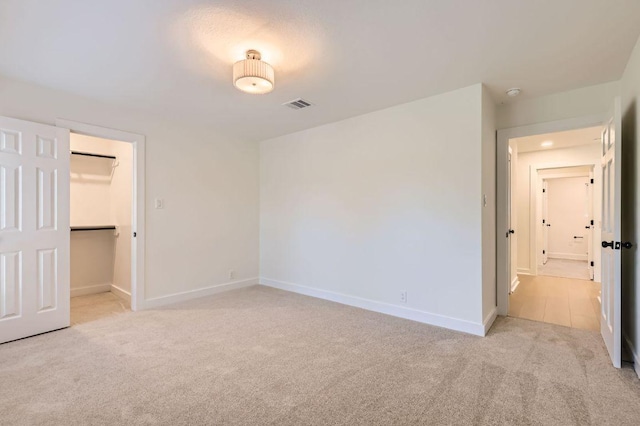 11108 Brista Way, Austin, TX 78726 - unfurnished bedroom featuring light carpet and a walk in closet