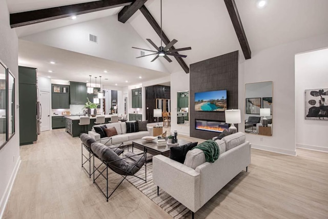 19125 Hopper Ln, Austin, TX 78738 - living area with high vaulted ceiling, light wood-style floors, beamed ceiling, a fireplace, and ceiling fan