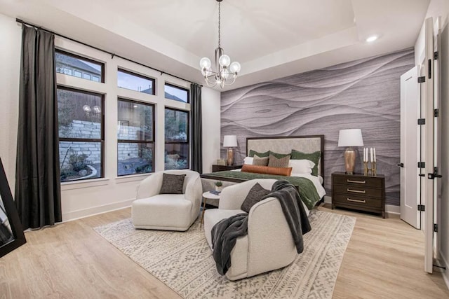 19125 Hopper Ln, Austin, TX 78738 - bedroom featuring an accent wall, wallpapered walls, a chandelier, light wood-style floors, and recessed lighting