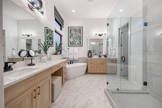 19125 Hopper Ln, Austin, TX 78738 - full bath with two vanities, a stall shower, a freestanding tub, marble finish flooring, and recessed lighting