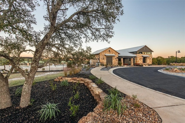 19125 Hopper Ln, Austin, TX 78738 - view of front of property with stone siding and a metal roof