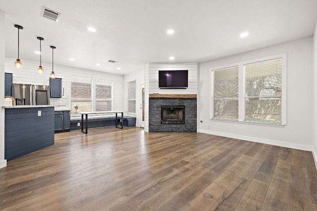 2208 Drue Ln, Cedar Park, TX 78613 - living room with recessed lighting, a fireplace, and dark wood-type flooring