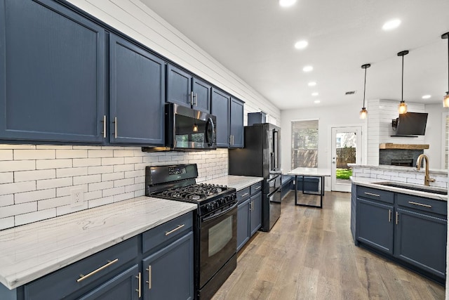 2208 Drue Ln, Cedar Park, TX 78613 - kitchen with black appliances, blue cabinets, tasteful backsplash, recessed lighting, and wood finished floors