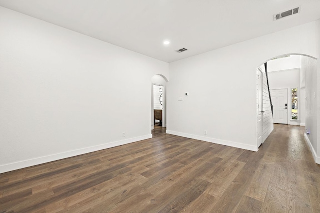 2208 Drue Ln, Cedar Park, TX 78613 - empty room with arched walkways, dark wood-style floors, and recessed lighting