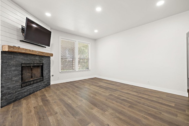 2208 Drue Ln, Cedar Park, TX 78613 - unfurnished living room with dark wood finished floors, a stone fireplace, and recessed lighting
