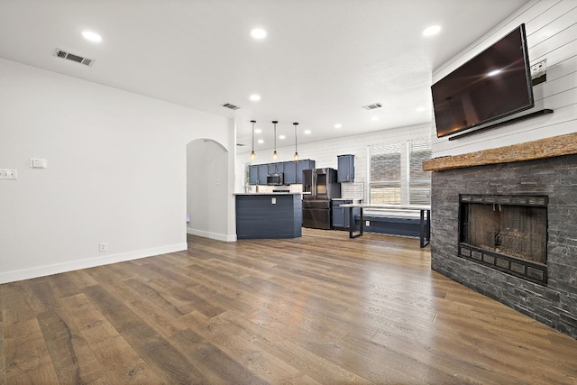 2208 Drue Ln, Cedar Park, TX 78613 - living area featuring arched walkways, dark wood finished floors, recessed lighting, and a fireplace