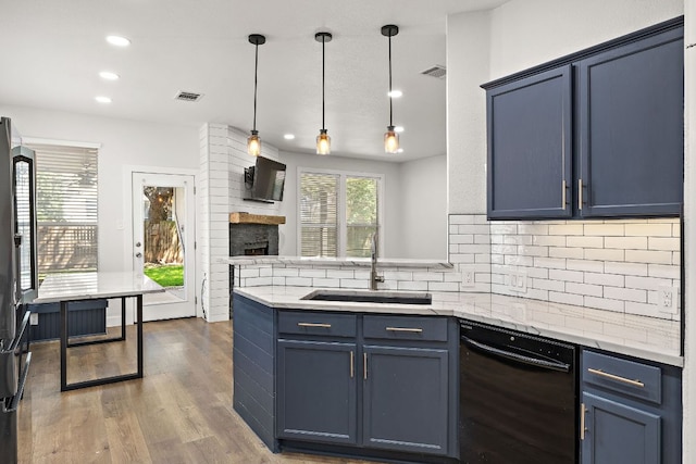 2208 Drue Ln, Cedar Park, TX 78613 - kitchen featuring black dishwasher, a peninsula, tasteful backsplash, a fireplace, and recessed lighting